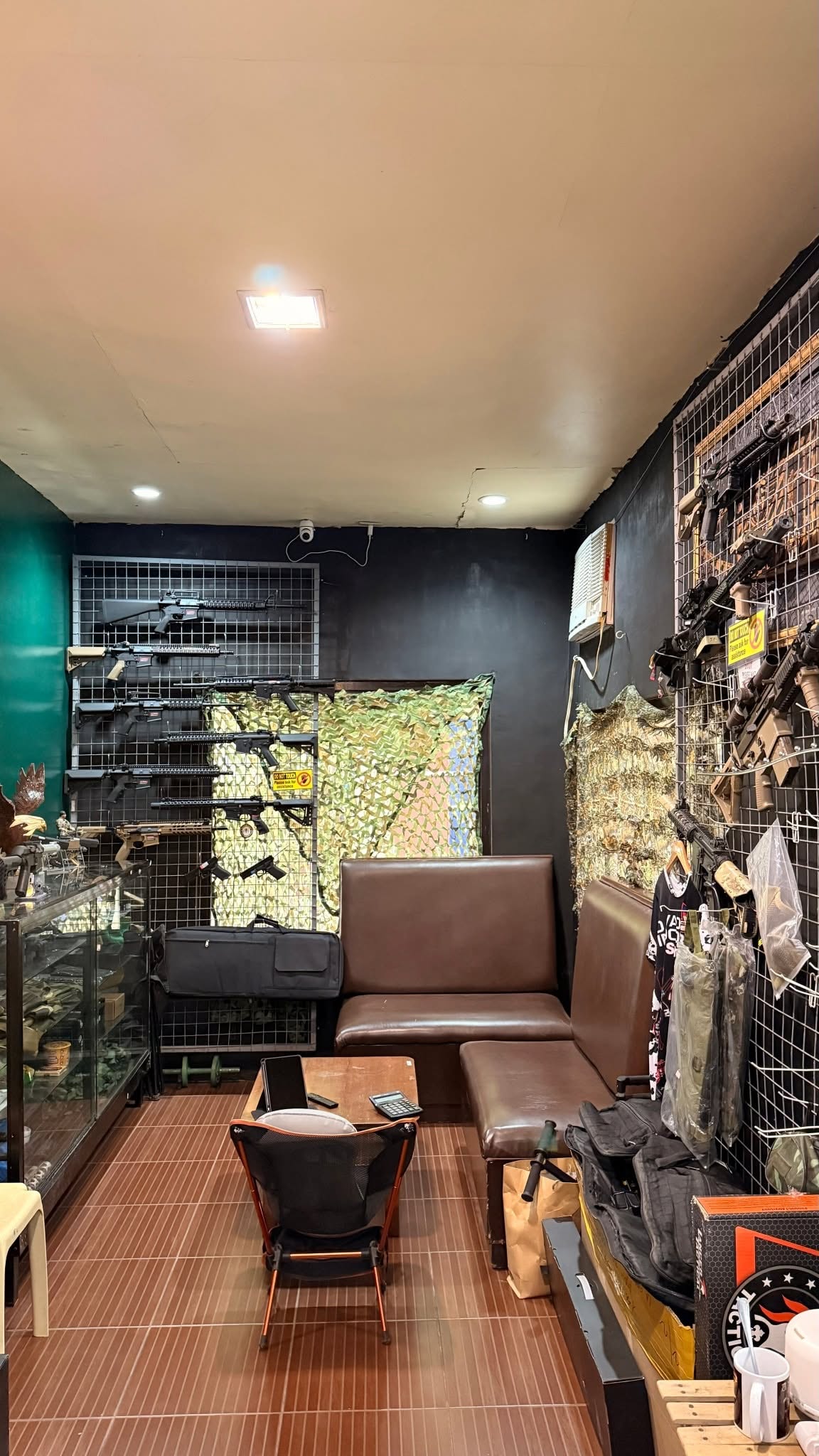 Inside the La Grae armory — gun wall and glass display cases
